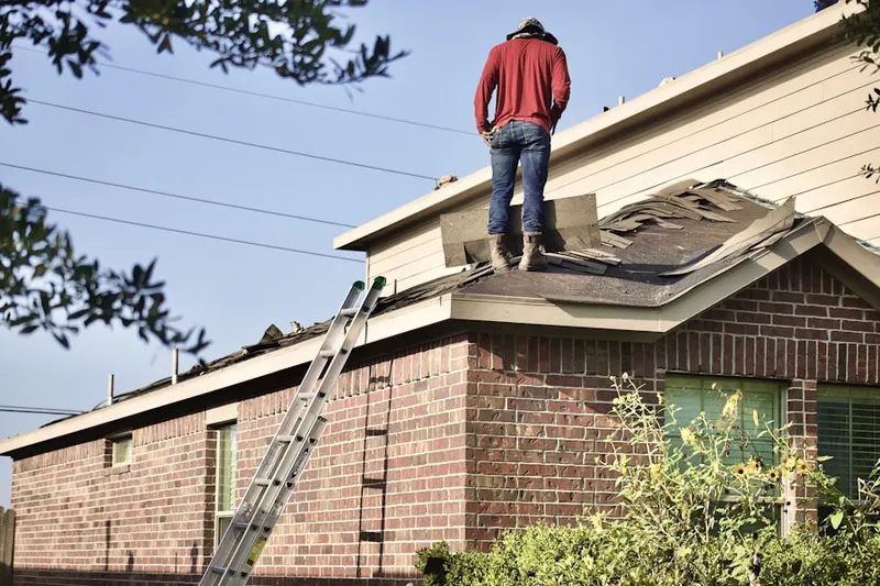 Professional roofer working on a residential roof in Legacy of Leesburg